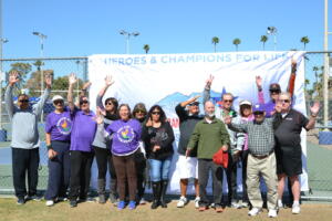 group of transplant recipients having fun in front of the TGA flag.