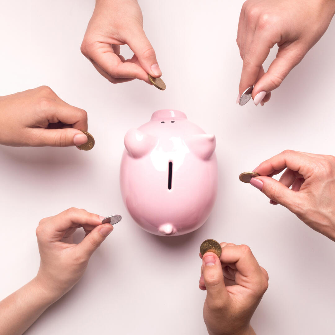 People hands throwing coins in piggy bank for crowdfunding